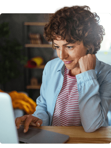 woman using laptop with elbow on table