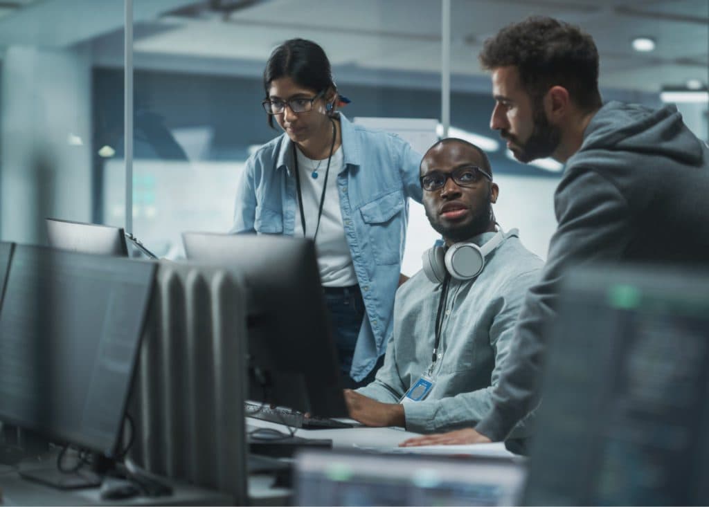 three people looking worried while working in an office