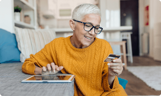 woman online shopping on tablet with credit card