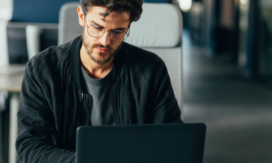 A man works at his computer, representing Dashlane’s Credential Protection product and how it provides proactive security for every employee.