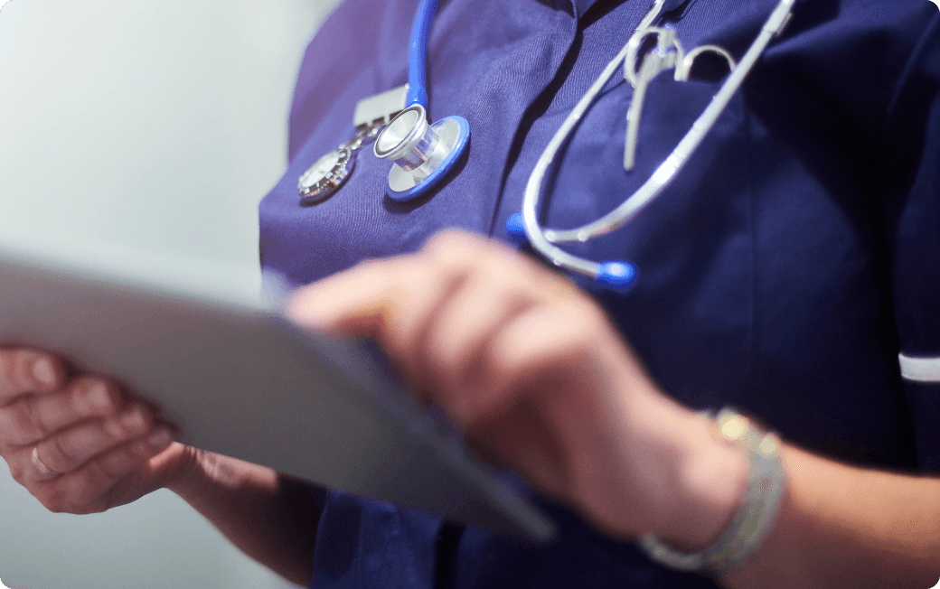 Medical professional working on a tablet.