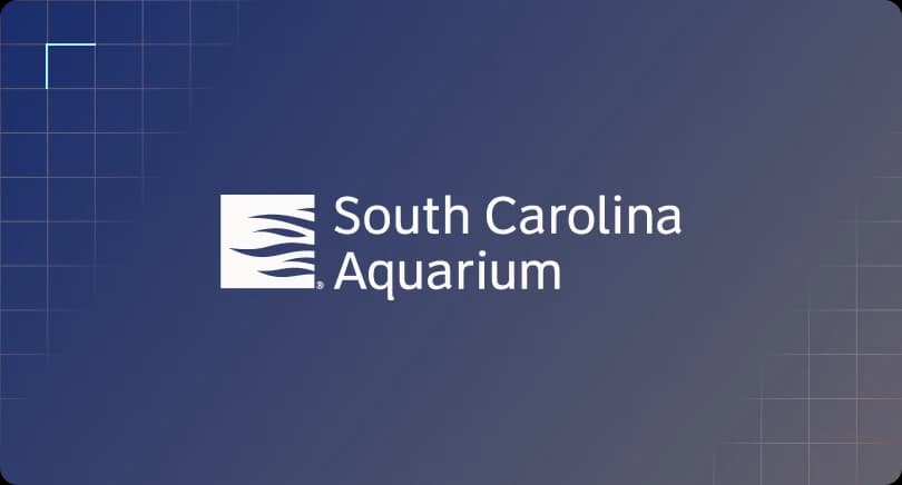 South Carolina Aquarium company logo centered on a dark blue grid background.