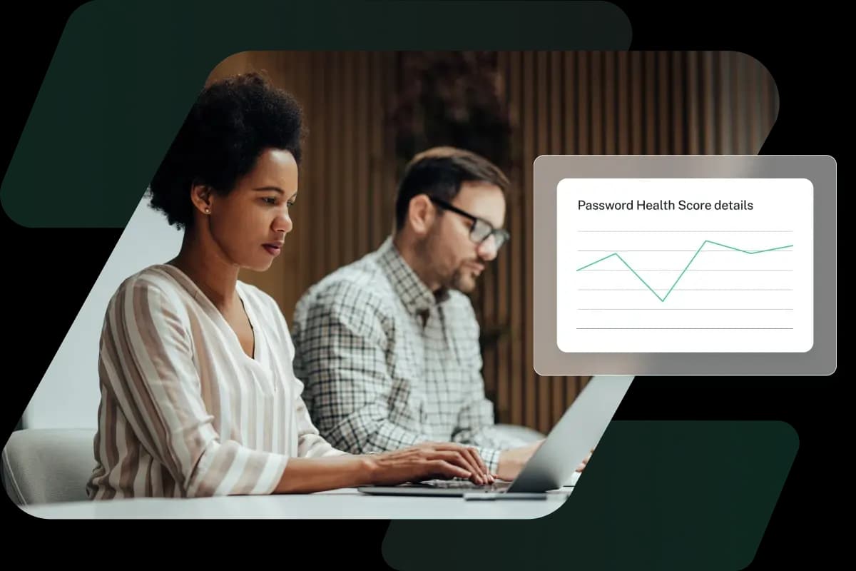 This image shows a man and a woman working at a shared desk with product imagery of Dashlane’s Password Health score, representing how Dashlane provides enterprise password management.