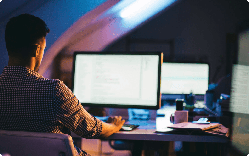 A man works at his computer, protected by Dashlane Omnix in his chosen browser.