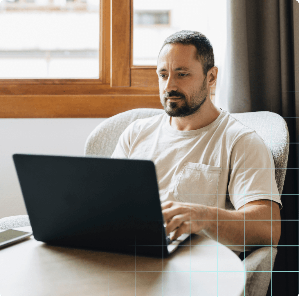 Man working at his computer at home.
